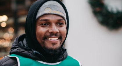 Smilling person with a benie pictured close