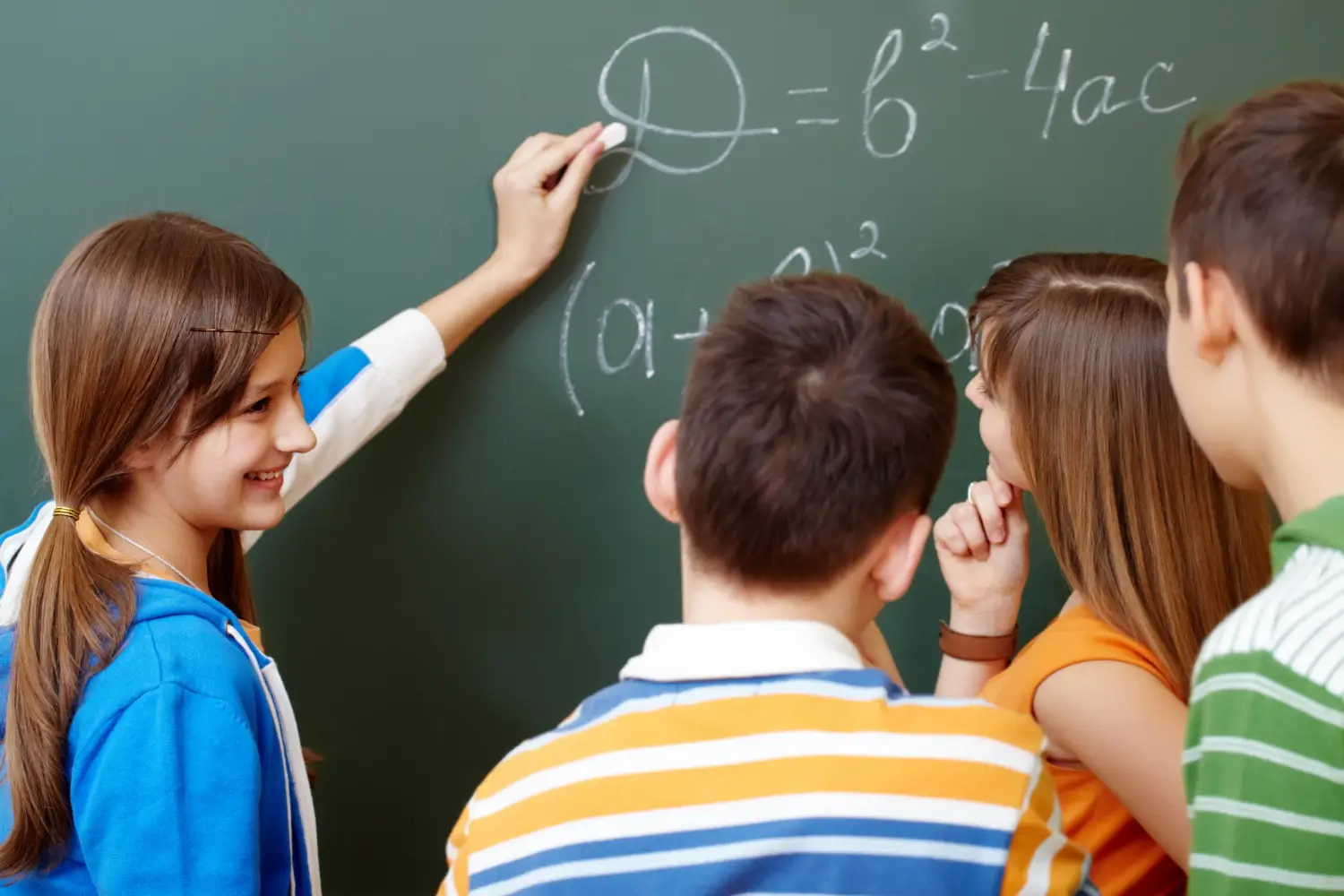Young teens drawing on a chalk board