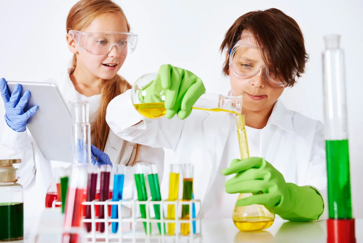 Two teens pouring chemicals in tubes