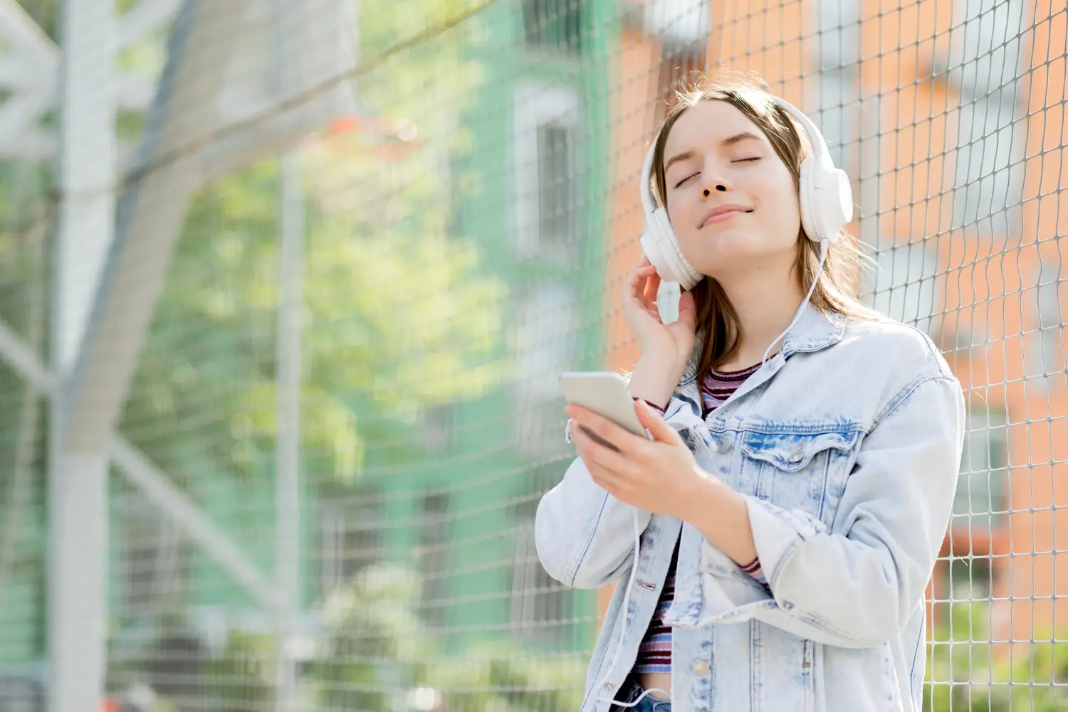 Person with headphones and a phone in hands