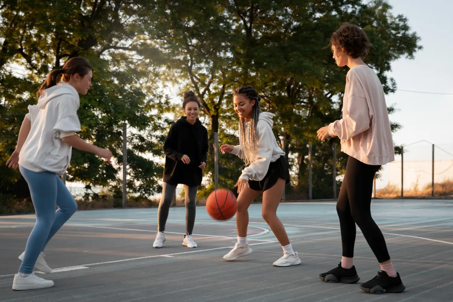 Teens playing basketball