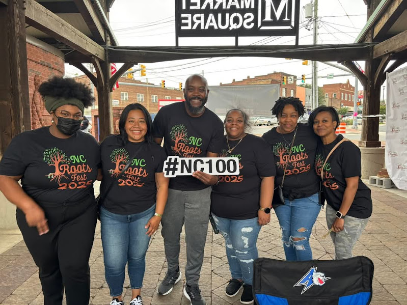 NC 100 team holding a #nc100 sign