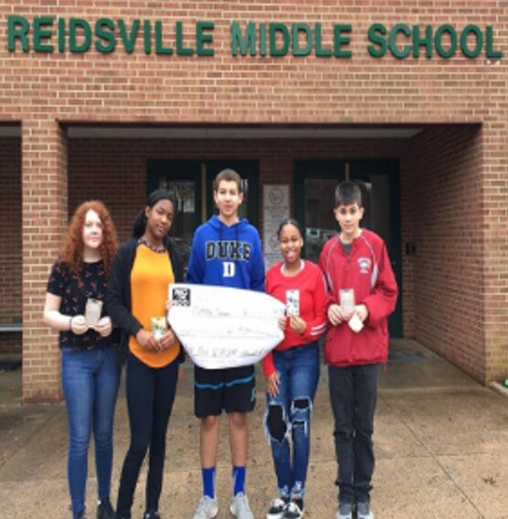 Teens holding a check